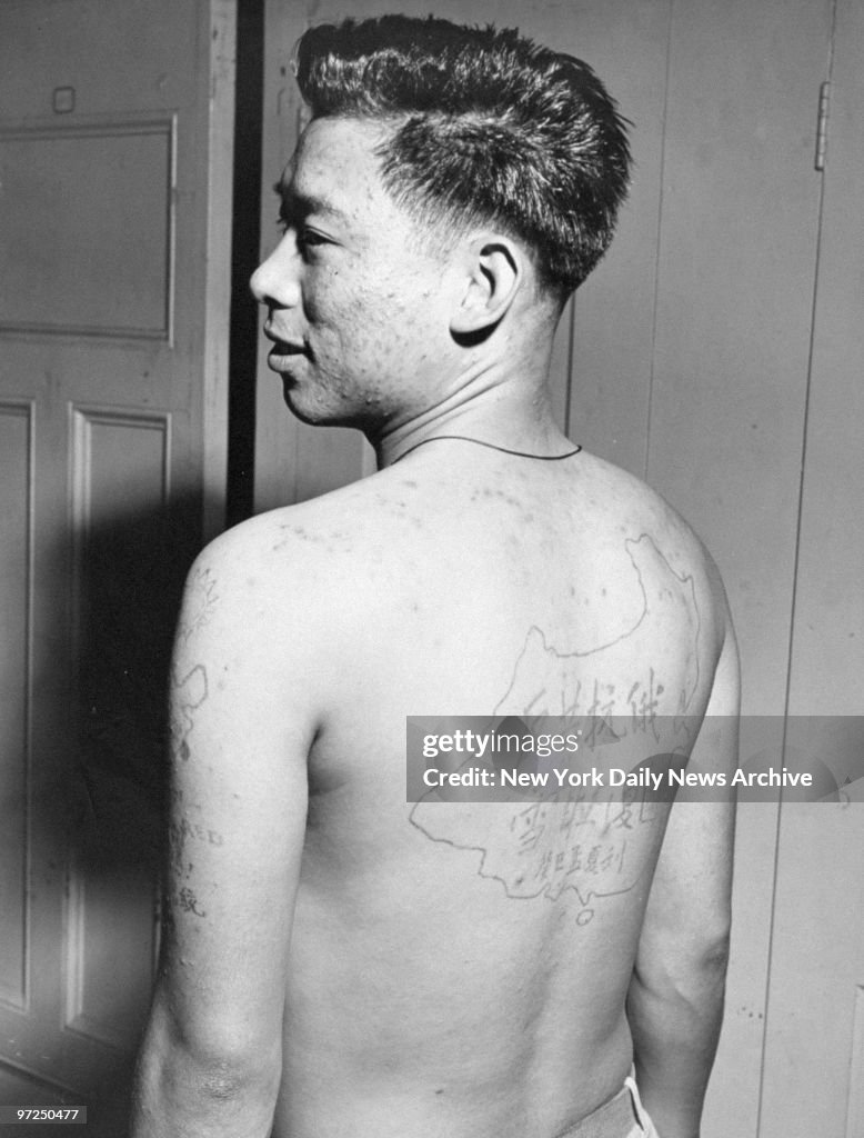 Anti-communist Chinese soldier shows tattoos he was given in