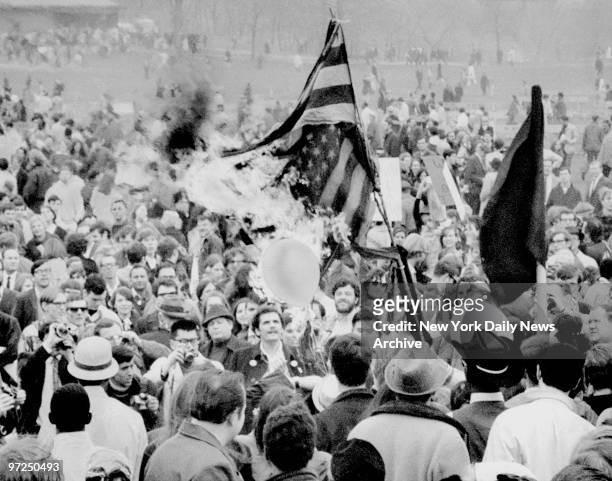Anti-Vietnam war demonstrators burning the American flag during demonstration in Central Park.
