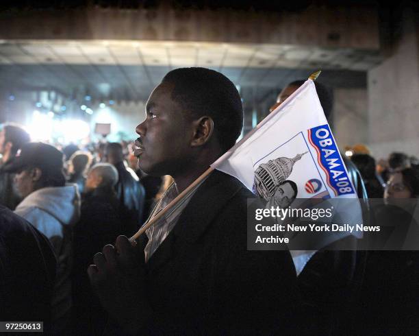Arbab Djaranabi of Brooklyn, holds an Obama flag as he watches results. New Yorkers react as election results are released as they watch television...