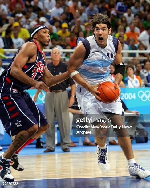 Argentina's Luis Alberto Scola drives on Shawn Marion of the U.S. During a men's semifinal basketball game at the 2004 Summer Olympic Games in...