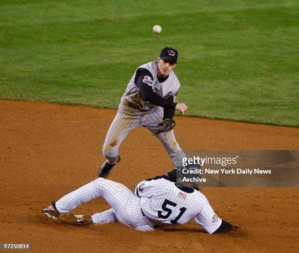 Arizona Diamondbacks' second baseman Craig Counsell gets the force out on Bernie Williams and throws to first to complete a double play in the fourth...