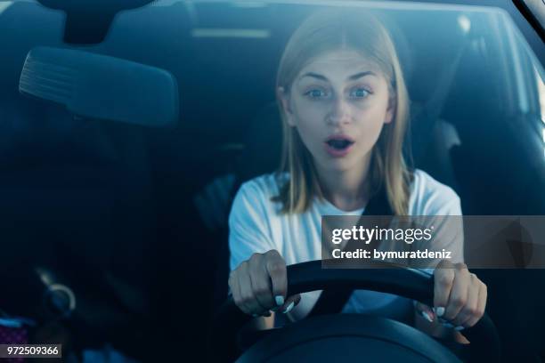 fright face of woman driving car - beautiful woman shocked stock pictures, royalty-free photos & images