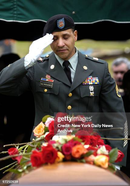 Army National Guard Sgt. Frankie Serrano, who has just returned from Iraq, weeps as he salutes the flower-strewn coffin of fellow soldier Cpl. Joseph...