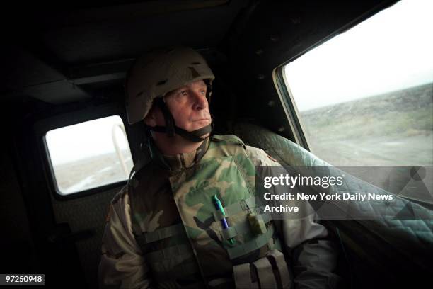 Army Reserve Medic Staff Sgt. James Dickerson rides in a 12-foot-high explosive-resistant vehicle called a Buffalo during a search for improvised...