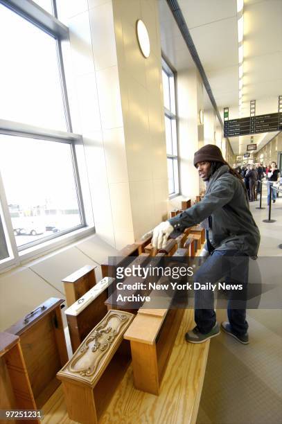 Artist Rondell Crier helps place drawers ravaged by the flood following Hurricane Katrina as part of the multimedia art installation "Floodwall" at...