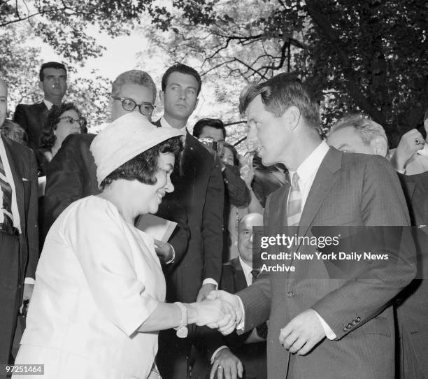 Attorney General Robert Kennedy greets Mrs. Luis Munoz Marin on reviewing stand during annual Puerto Rican Day Parade up Fifth Ave. The colorful...