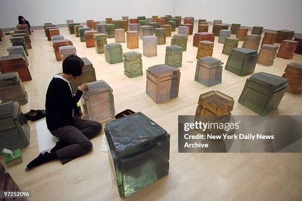 At the "Sensation" exhibition at the Brooklyn Museum of Art: Putting finishing touches on Rachel Whiteread's "One-Hundred Spaces."