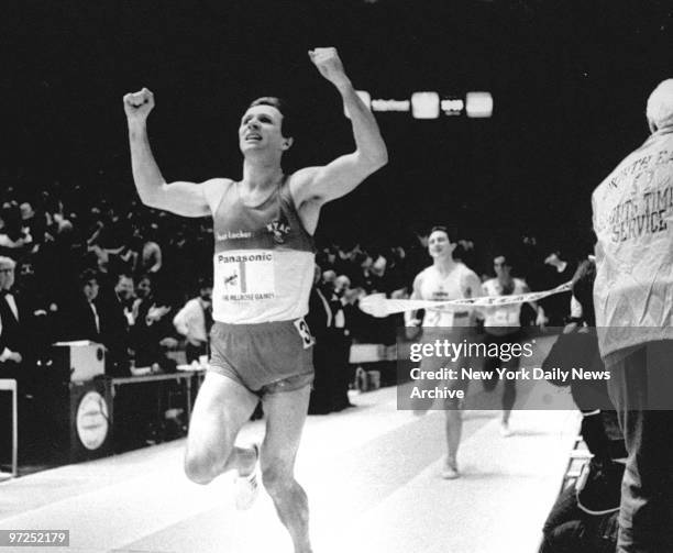 Eamonn Coghlan crosses the finish line after capturing his seventh Wanamaker Mile at the Milrose Games.