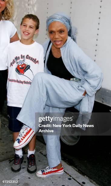 Eartha Kitt, accompanied by grandson Jason shows off her red, white and blue sneakers before singing in an all-star rendition of the classic Sister...