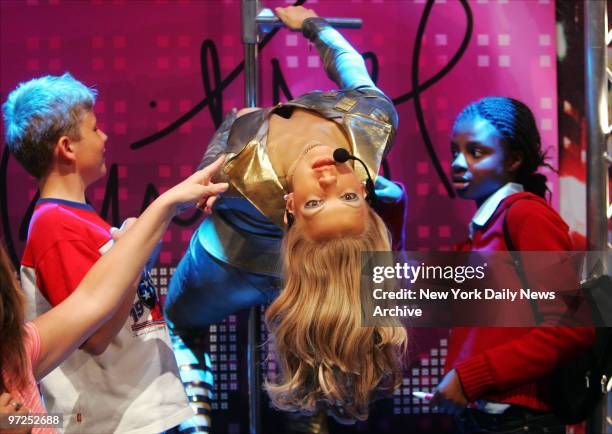 Eddie McCarthy of Breezy Point, Queens, and Aicha Nanbji of Jamaica, Queens, look over the new "Britney Spears of 2000" figurine at Madame Tussauds...