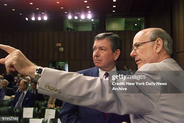 Attorney General John Ashcroft confers with Sen. Pat Roberts before testifying at a Senate subcommittee hearing on terrorism.