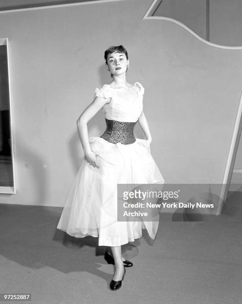 Audrey Hepburn star of Broadway play "Gigi" shows new waist nippers.