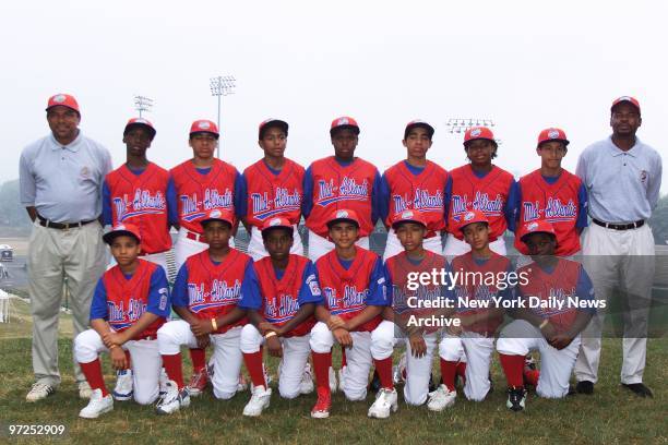 Harlem Little League baseball team members have a team photo taken at Howard J. Lamade Stadium in Williamsport, Pa., before the opening ceremony of...