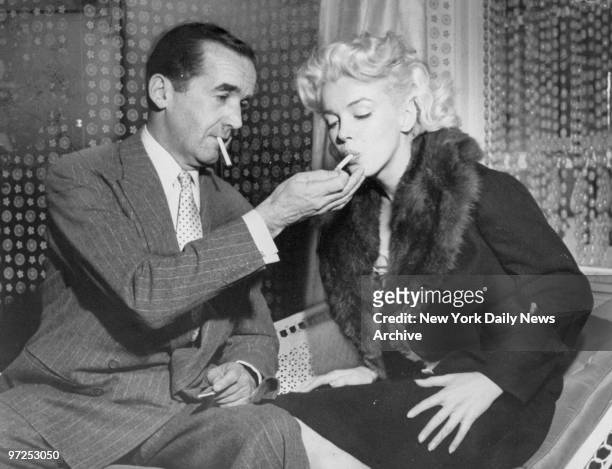 Edward R. Murrow lights cigarette for Marilyn Monroe during interview on television show "Person to Person."
