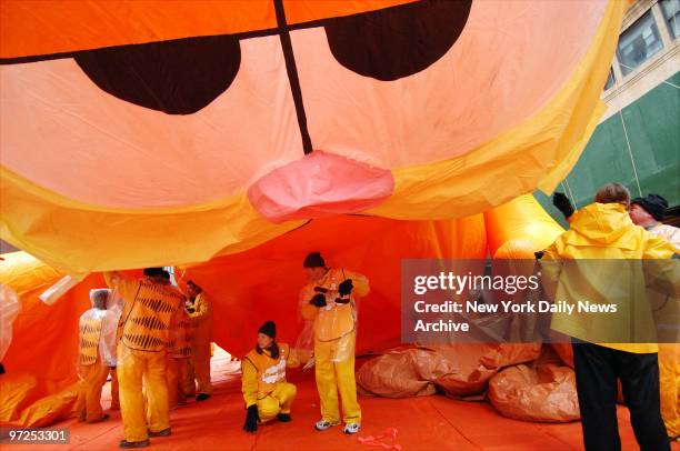 Handlers deflate the Garfield balloon at the end of the 80th annual Macy's Thanksgiving Day Parade. Despite gusty winds and intermittent rain, a...