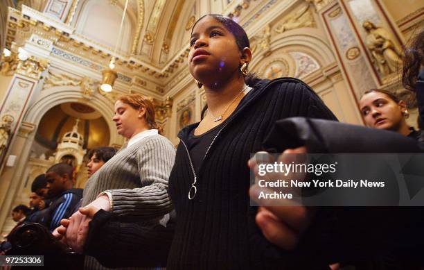 Eighth-grade classmates of Randy Carlote join hands at his funeral in St. Barbara's Catholic Church in Bushwick, Brooklyn. The 13-year-old boy, who...