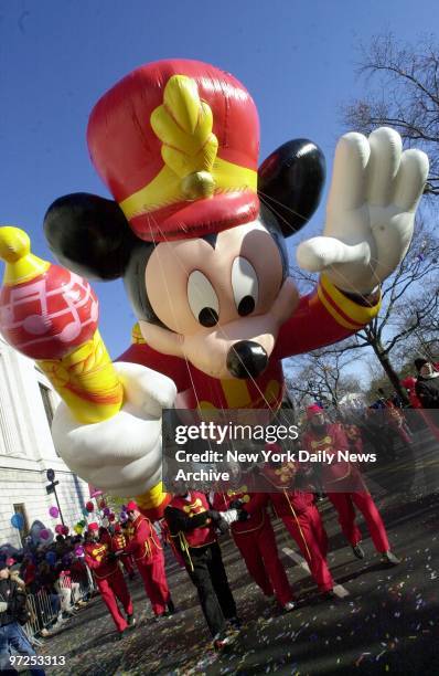 Handlers guide the bandleader Mickey Mouse balloon as it leads the 74th annual Macy's Thanksgiving Day Parade down Broadway.