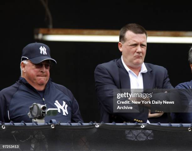 Hank Steinbrenner and guest instructor Stump Merrill watch as pitchers throw in the bullpen at Legends Field during team's first full-squad workout...