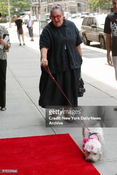 Author Kim Hastreiter and Romeo, her white Dandie Dinmont terrier, arrive at Trinity restaurant in TriBeCa for Romeo's fourth birthday party.