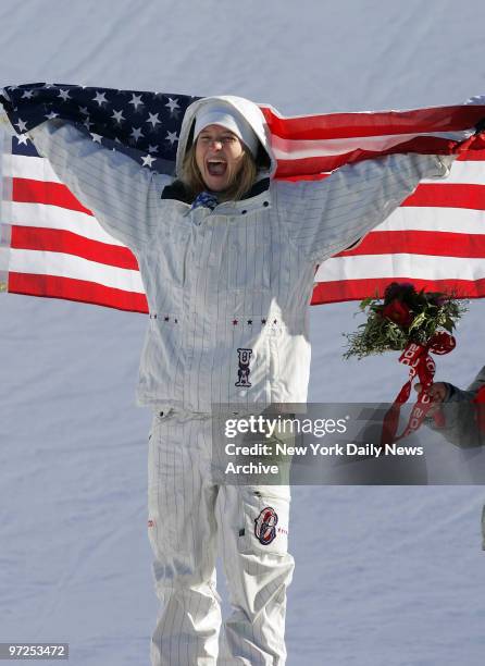 Hannah Teter of the U.S. Celebrates winning the gold medal in the Women's Halfpipe Snowboard competition in Bardonecchia during the 2006 Winter...