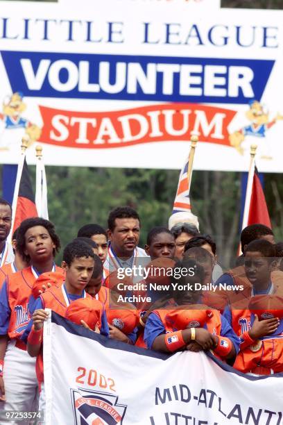 Harlem Little League team members carry banner during Little League World Series opening ceremonies at Howard J. Lamade Stadium in Williamsport, Pa.