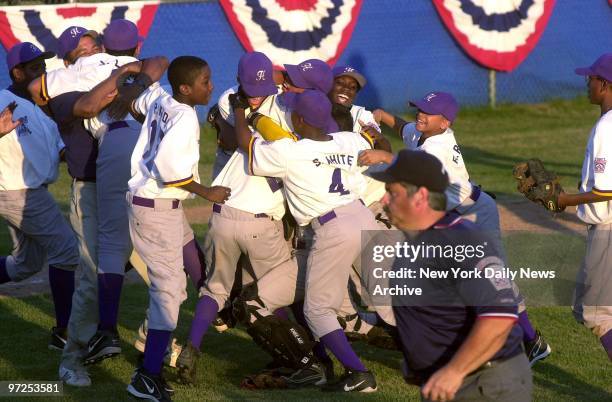 Harlem Little Leaguers celebrate their 7-5 win over Delaware's Lower Sussex Little League team during the 16th Annual Little League Baseball Eastern...