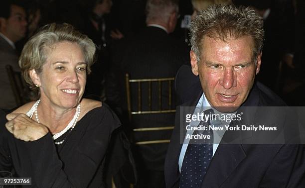 Harrison Ford and his wife, actress Melissa Mathison, share a table at the Amnesty International Media Awards at the Chelsea Piers. He was honored at...