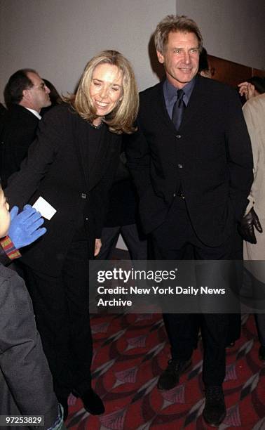 Harrison Ford and wife Melissa Mathison attending premiere of movie "Kundun" at Loews Astor Plaza theater. Melissa is the screenwriter of the movie.