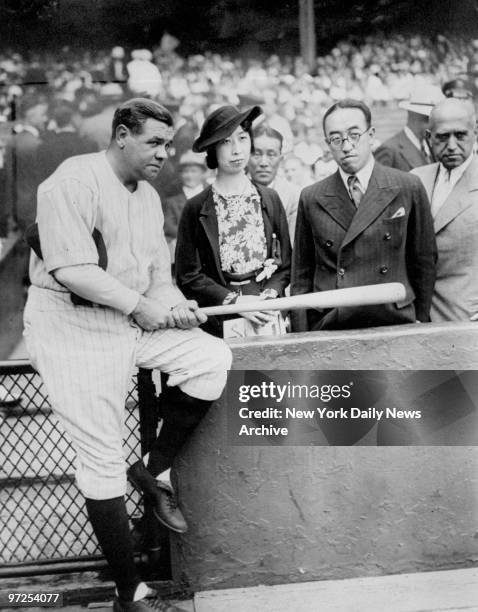 Babe Ruth holds autographed bat for Princess and Prince Kaya of Japan at Yankee Stadium where the Yankees went on to defeat the Detroit Tigers....