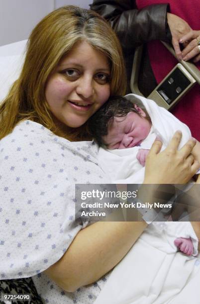Elsa Novoa cuddles her new son - who entered the world just as mom was about to enter the Queens Midtown Tunnel - at Elmhurst Hospital Center. Novoa...