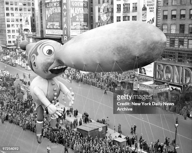 Pinocchio balloon floats down Broadway in thirteenth annual Macy's Thanksgiving Day parade. Seven musical organizations, twenty-one floats and...