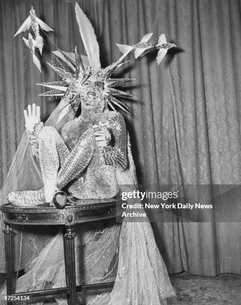 Harry Gemini of New York City, dressed as a sea monster, takes a smoke at the Bal Fantastique at the Sheraton Astor.