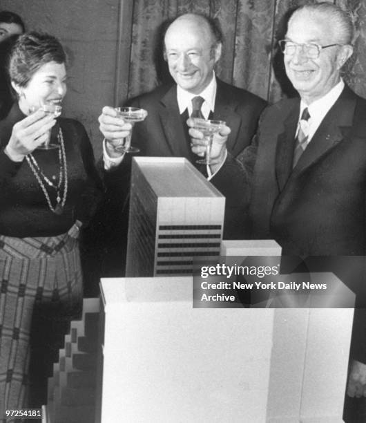 Harry Helmsley and wife Leona toast to their Palace Hotel model with New York Mayor Ed Koch.