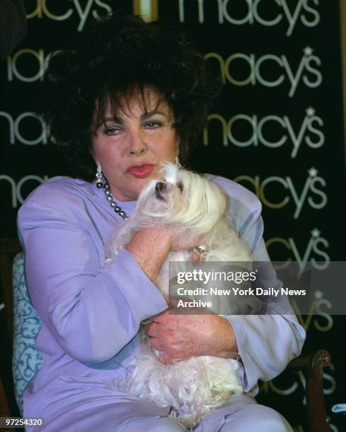 Elizabeth Taylor and her dog "Sugar" at Macys Dept Store for her Black Pearl Perfume.