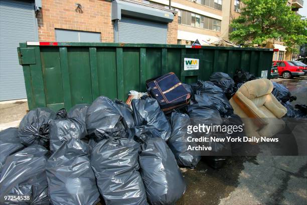 Bags of garbage are piled next to a dumpster on Park Ave. In West New York, N.J., in which the body of Jennifer Moore was found early this morning....
