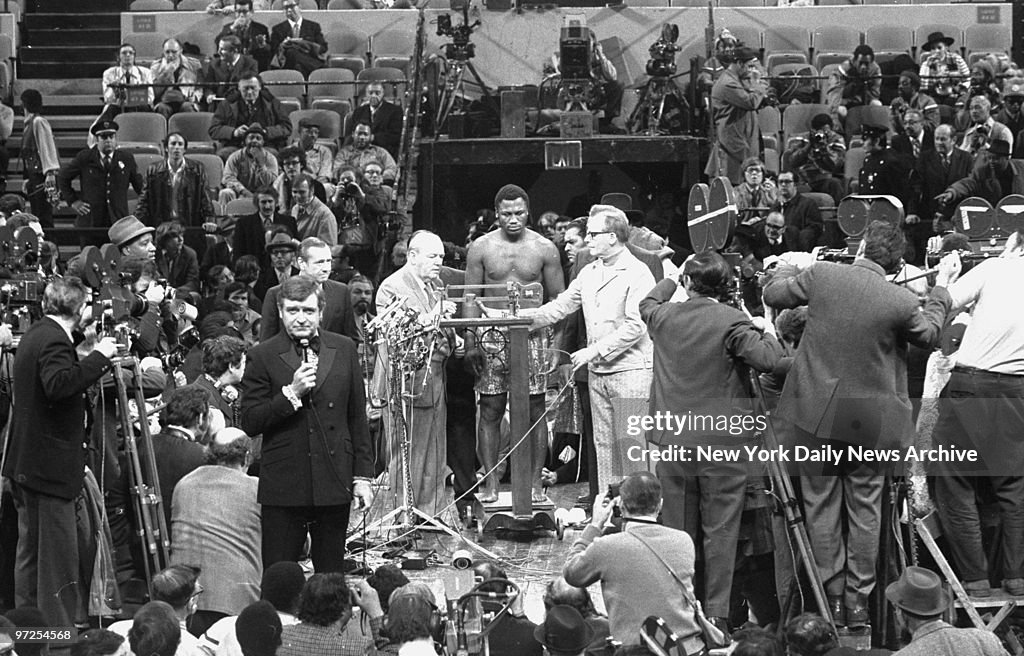 Heavyweight champ Joe Frazier on the scale as Commissioner E