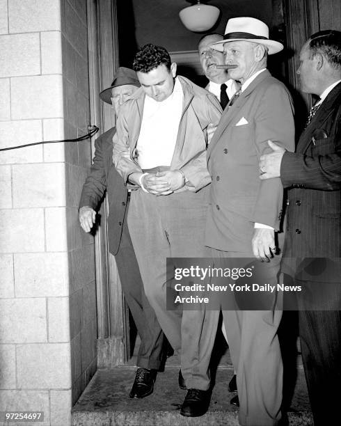 Head bowed, David Greenglass of 262 Rivington Street, leaves Federal Court after being remanded to jail in lieu of $100,000 bail on charges of...