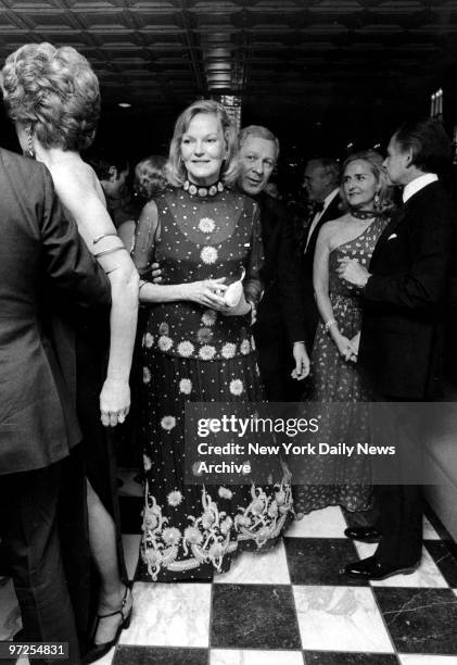 Elusive and mysterious Doris Duke enjoys herself on the dance florr walking behind her is host of party Ray Kassar