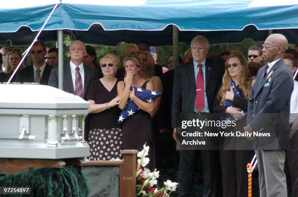 Heather Duggan is comforted by her mother as they stand with Daniel and Maureen Murphy during funeral services for the Murphy's son, Michael Murphy,...