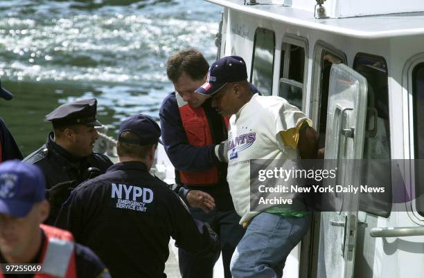 Ernesto DeJesus is removed from a police boat after he was taken into custody in Staten Island. He was charged with assault in the slashing of a...