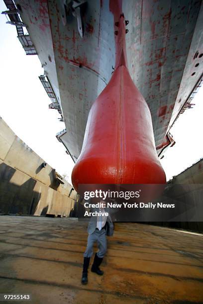 Bill White, president of the Intrepid Sea-Air-Space Museum clowns around under the keel of the World War 2 era aircraft carrier, while it sits on...