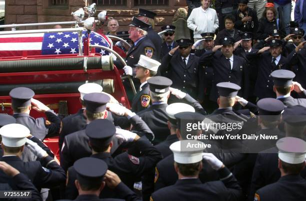 Fellow firefighters salute as the coffin of David Fontana passes by during a memorial service at St. Francis Xavier Church on Sixth Ave. In Park...