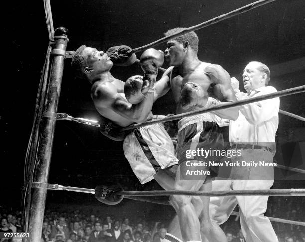 Emile Griffith vs Benny Paret, Benny Paret lies helpless against ropes as flailing fists of Emile Gfriffith batter him into unconsciousness during...