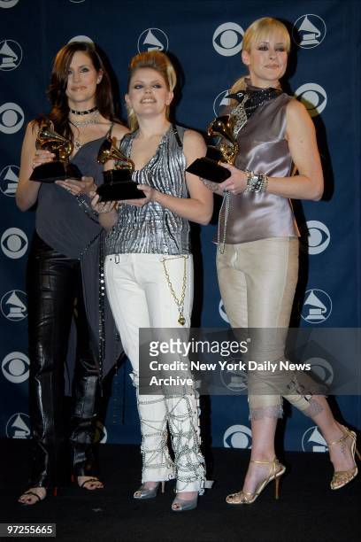 Emily Robison, Natalie Maines and Martie Seidel of The Dixie Chicks hold their awards for Best Country Performance by a Group, Best Country Album and...