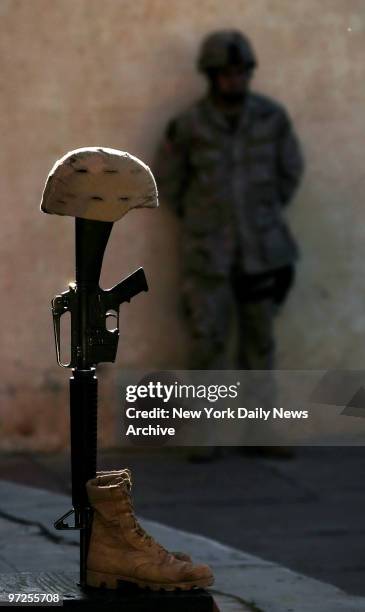 Helmet, boots and rifle stand as a memorial during service for PFC Kevin Luna in Diyala province, north of Baghdad, Iraq. Luna was killed when he was...