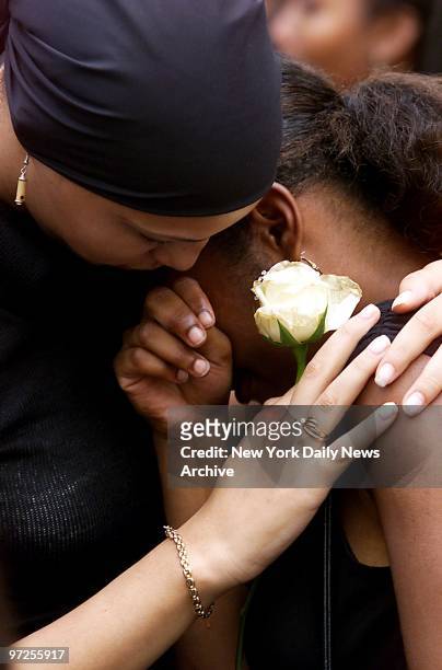 Holly Ganesh comforts her friend, Nicole Edwards, outside St. Ignatius Loyola Roman Catholic Church on E. 84th St., where a funeral service was held...