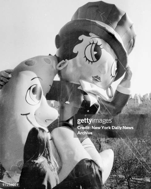 In the Macy's Thanksgiving Day Parade, Betty Boop balloon is seen through window on eighth floor of 88 Central Park West.