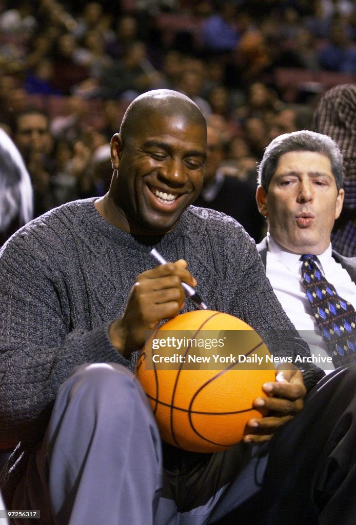 Basketball legend Earvin (Magic) Johnson autographs ball for