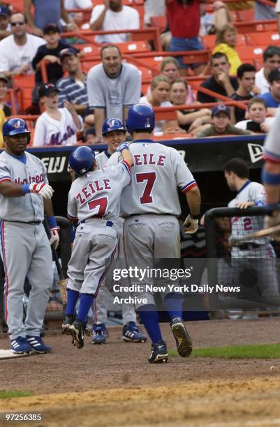 Batboy Garrett Zeile, the son of Montreal Expos' Todd Zeile, leaps up to congratulate his dad after Zeile hit a go-ahead solo homer to left center...