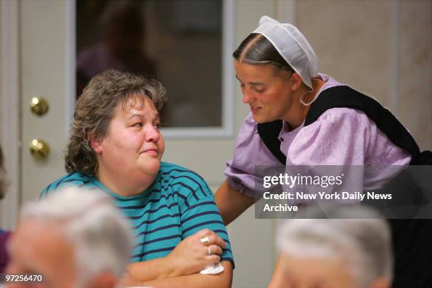 Bay St. Louis resident Cynthia Warner speaks with Ruth Esch during a sharing night for the Waveland and Amish communities at an Amish camp near the...